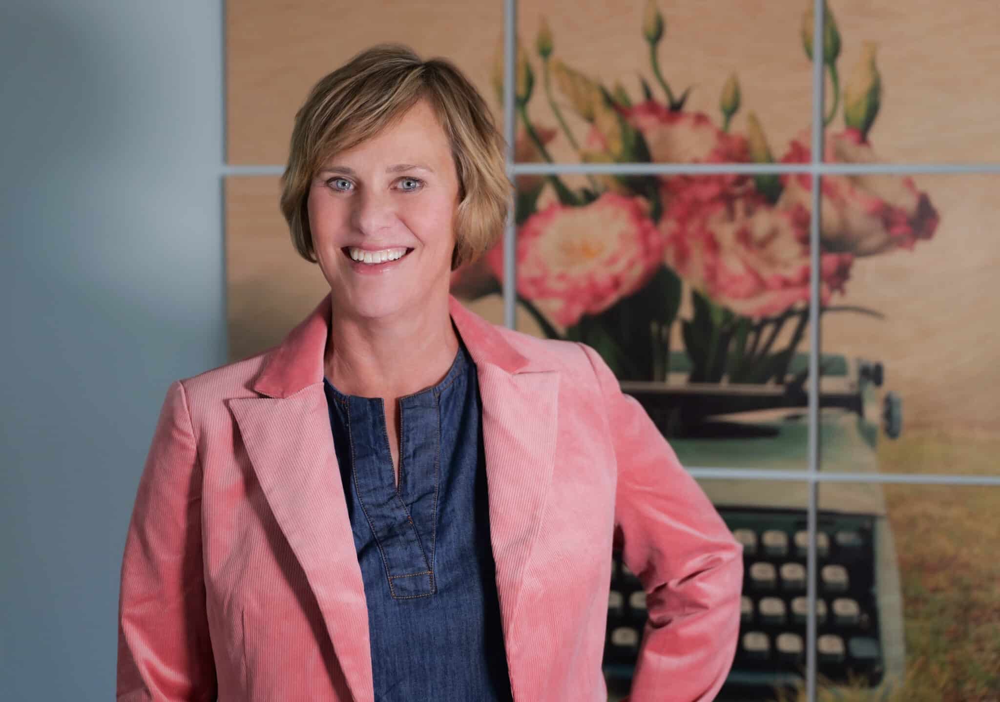 Jen Singer pink jacket headshot 2024